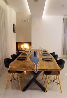 a wooden table with black chairs around it