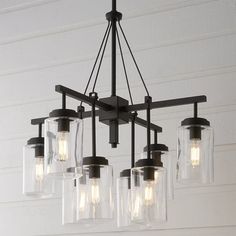 a chandelier with five glass jars hanging from it's center and four lights on each side