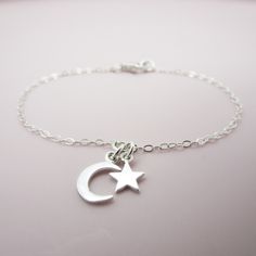 ALL SOLID STERLING SILVER PARTS - A QUALITY BRACELET This high quality bracelet is made using adorable sterling silver charms in a moon and star shape. A sturdy sterling silver chain and lobster clasp make this a durable bracelet. Comes in a gift box perfect for gift giving. Moon charm measures approximately 3/8 inch tall and the star 1/4 inch tall. SIZING - IMPORTANT: To determine bracelet size, measure snugly around your wrist and add 1/2 inch to get your bracelet size. Do NOT order in your ex Moon And Star Bracelet, Moon Bracelet, Sterling Silver Charms, Tiny Star, Bridesmaid Bracelet, Moon And Star, Star Bracelet, Silver Moon, Moon Charm