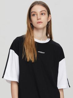 This casual T-shirt features color-blocking design to create sporty mood. It is made from comfortable 20's single cotton jersey.- Ribbed round neck- Logo embroidery at front - Double stripe tapes at sleeves- Point logo label at hem- Loose fit- Unisex wear- Tentar and tumble finish to minimize distortion after wash Relaxed Fit Crew Neck T-shirt With Contrast Color, Black Tops With Contrast Color And Relaxed Fit, Black Relaxed Fit Top With Contrast Color, Urban Cotton Color Block Tops, Black T-shirt With Contrast Color In Relaxed Fit, Black T-shirt With Contrast Stripes For Streetwear, Black Striped T-shirt For Streetwear, Sporty Black T-shirt With Contrast Stripes, Black Graphic Tee With Contrast Color