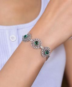 Introducing our exquisite 925 Sterling Silver Handcrafted Filigree Art Sun Figured Women's Adjustable Link Bracelet. This beautiful bracelet features a captivating sun-inspired design meticulously handcrafted with filigree artistry, showcasing intricate details and a touch of elegance. Mounted at the center of the bracelet is a stunning 6 mm double side faceted, round cut May birthstone, lab created Emerald gemstone. The emerald gemstone, known for its vibrant green hue and natural brilliance, s Silver Bracelets With May Birthstone, Elegant Crystal Gemstone Bracelet, Ornate Cubic Zirconia Jewelry, Silver Crystal Bracelet For May Birthstone Gift, Ornate Round Cubic Zirconia Jewelry, Silver Bangle Bracelet For May Birthstone, Silver Bracelet For Anniversary With May Birthstone, Elegant Sterling Silver Bracelets For May Birthstone, Green Bracelet With Stone Setting As Gift