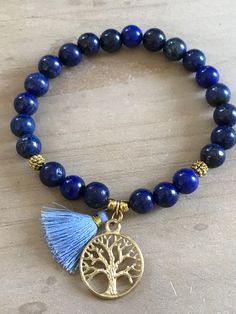 This beautiful bracelet is made of 8mm lapis lazuli beads, gold spacers and it is adorned with a tree of life pendant and a mini tassel 20mm. The bracelet shown fits to 7.75 inches wrist but you can choose your own wrist size. Lapis Lazuli *third eye and throat chakra *stimulates wisdom and good judgement *activates the higher mind and enhances intellectual ability *enhances the desire for knowledge, truth and understanding *is a stone of truth that deepens communication with calmness and loving Bohemian Lapis Lazuli Bracelet As A Gift, Bohemian Lapis Lazuli Bracelet For Gift, Bohemian Lapis Lazuli Beaded Bracelets, Bohemian Lapis Lazuli Beaded Bracelets As Gift, Handmade Lapis Lazuli Bracelets For Meditation, Spiritual Bracelets, Tree Of Life Bracelet, Lapis Lazuli Bracelet, Lapis Lazuli Beads