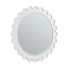 a white round mirror with scalloped edges