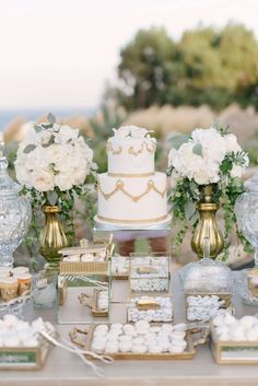 a table topped with lots of cakes and desserts