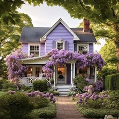 a house with purple flowers on the front