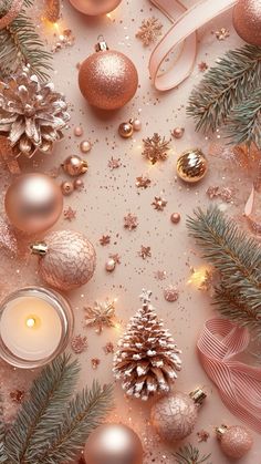 christmas decorations and candles on a white background with pink ribbon, pine cones, snowflakes and bows