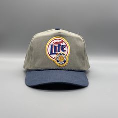 "80s/90s retro 2-tone trucker rope snapback hat with a Vintage Miller Lite Logo Beer Patch \"Miller Lite Boy\" * Khaki/Navy * One Size Fits Most * 5-Panel Stone Washed Canvas, 2-Tone * High Profile, 3 ¾\" Structured Crown * Half-Moon * Snapback Closure **We try to provide every angle in the pictures so please read the description carefully of product listing, size, & fit description & measurements. Also please ask any questions about sizing prior to ordering if you are concerned. Follow us on IG Retro Adjustable Snapback Hat For Sports, Retro Flat Brim Snapback Hat For Baseball Season, Retro Adjustable Fitted Hat For Baseball Season, Retro Fitted Hat For Baseball Season, Retro Fitted Hat With Flat Bill For Outdoor, Retro Trucker Hat For Baseball Season, Retro Flat Brim Hats For Baseball Season, Adjustable Curved Brim Trucker Hat Throwback Style, Throwback Adjustable Trucker Baseball Cap