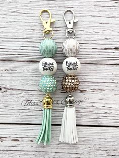 the key chain is decorated with beads and tassels, which are attached to each other