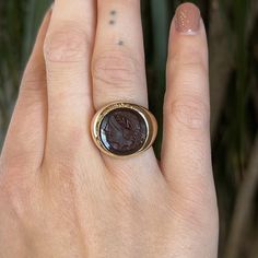 This extremely rare Mid-Century Intaglio ring features an engraved sardonyx set in 10 karat yellow gold. Intaglio rings date as far back as 5000 BC and often depict Neoclassical impressions of warriors and emperors. This cocktail ring features a red sardonyx stone with a deep Vermillion hue. Sardonyx is banded gemstone and variety of chalcedony. This sardonyx features a Roman carving set in a bezel of 10 karat yellow gold. A sister to Cameo jewelry with a scarlet red hue. A right hand ring with Sardonyx Stone, Intaglio Ring, Right Hand Ring, Cameo Jewelry, Right Hand Rings, Hand Ring, Metal Shop, Gold Filigree, Shop Engagement Rings