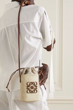 LOEWE + Paula's Ibiza Square Pocket leather-trimmed raffia bucket bag | NET-A-PORTER Loewe Paula's Ibiza Bag, Loewe Straw Bag, Loewe Raffia Bag, Raffia Bucket Bag, Interesting Websites, Loewe Paula's Ibiza, Loewe Bags, Square Pocket, 2024 Ideas