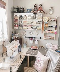 a sewing machine sitting on top of a white table next to a desk and chair