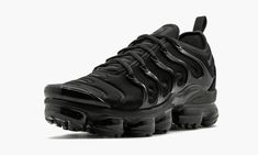 The Nike Air VaporMax Plus "Triple Black" originally released in 2018.  It is a fusion model that combine Nike's futuristic VaporMax cushioning system with the design DNA of the popular Nike Air Max Plus.  A neoprene upper sporting similar details to the 1998 runner is accented by reflective tabs running up the tongue.  A black TPU lacing cage has been added to resemble the represent the overlays on the original Air Max Plus.  Special "Vm Air" logos don each heel and insole as a nod to the yello Triple Black Shoes, Boots Uggs, Nike Air Max Jordan, Buy Nike Shoes, Air Vapormax Plus, Nike Air Vapormax Plus, Nike Vapormax, Air Vapormax, Nike Air Max Plus