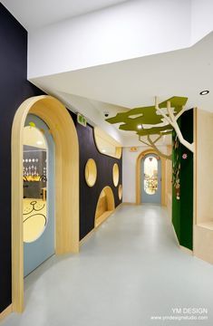 the interior of a building with colorful walls and arched doorways that lead to an indoor play area