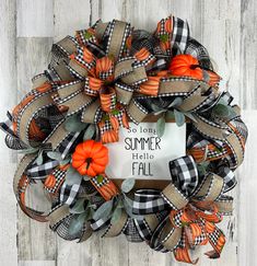 an orange and black wreath with the words hello fall on it