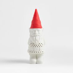 a white gnome figurine with a red hat