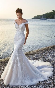 a woman in a wedding dress on the beach