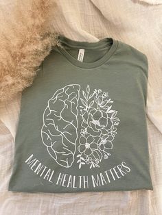 Your Mental Health MATTERS!  May is Mental Health Awareness month and Green is the color for Mental Health Awareness so this shirt is on a Heathered Sage Green Bella Canvas Tee also available in Sand (Gildan Shirt) with black vinyl.  matching Iced coffee Cup is also available here:  https://www.etsy.com/listing/1141509276/mental-health-matters-beer-can-glass?ref=listings_manager_grid Made using a heat press and premium vinyl Sizes are unisex so order true to size or go up a size for an oversized Green Letter Print Shirt For Spring, Mental Health T Shirts, Mental Health Awareness Month, Iced Coffee Cup, Awareness Shirt, Bella Canvas Tees, Young T, Mental Health Matters, Health Matters