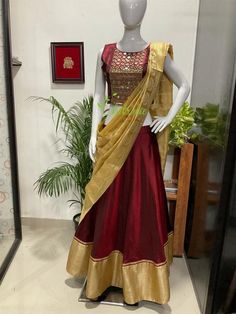 This Lehenga is made of pure soft silk fabric. The outfit is lined with satin.You can choose cotton or satin for lining. The outfit consist of crop top, skirt and dupatta.The top is heavily embroidered with mirrors and beads.A golden boarder is given at the hem edge of the skirt.Dupatta edges finished with a maroon beading.The colours can be customise according to your requirements.The outfit is a made to order dress. I will send a measurement sheet once you place the order. Designer Cotton Silk Sets For Navratri, Satin Saree Sets With Zari Work, Fitted Cotton Silk Lehenga In Traditional Drape, Traditional Satin Saree Set, Silk Sets With Cutdana For Festivals, Traditional Embroidered Long Skirt Set, Bollywood Style Cotton Silk Sets With Cutdana, Cotton Silk Sets With Traditional Drape For Festivals, Traditional Satin Sets With Unstitched Blouse