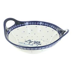 a blue and white serving bowl with handles on it's sides, decorated with flowers