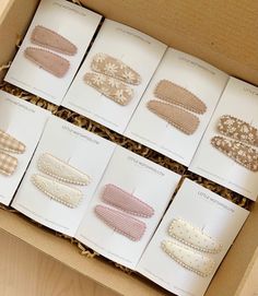 six pairs of headbands in a box on a table with other items inside