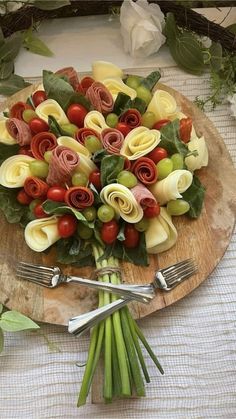 a wooden plate topped with flowers and vegetables