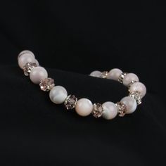 You'll love the soft pink colors in our pink mother of pearl bracelet. We've combined pink crystals and sterling silver accent beads for a delicate look. A beautiful gift for women of all ages! ABOUT: * Materials: sterling sliver lobster claw and sterling silver 1.5 inch extension * Beads: mother of pearl, glass beads, sterling bead caps * Width: 8mm SHOP OUR BRAND > https://rosaperlina.etsy.com WHAT IS STERLING SILVER? * Sterling silver is a mix of 92.5% of silver and 7.5% of other metals, typically copper. * The added copper gives sterling silver a great durability and strength. * Benefits are durability, higher percentage of real silver and better for sensitive skin. HOW TO CARE FOR STERLING SILVER? * Keep in an airtight container, away from moisture, heat, and sun in storage * Keep awa Pearl White Faceted Beads Jewelry Gift, Pearl White Jewelry With Faceted Beads As Gift, Pearl White Jewelry With Faceted Beads For Gifts, Elegant Silver Jewelry With Pink Opal, Elegant Adjustable Pink Bracelet, Elegant Beaded Pearl Bracelet For Mother's Day, Elegant Pink Opal Jewelry Gift, Elegant Pink Opal Jewelry For Gift, Elegant Silver Pink Opal Jewelry