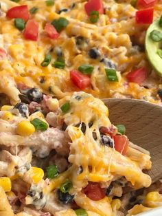 a casserole dish with chicken, black olives, and corn