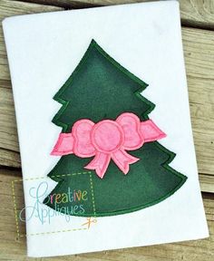 a christmas tree applique with a pink bow