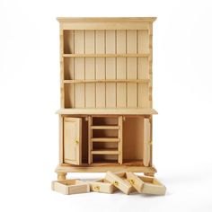 a wooden dollhouse furniture set with drawers and cupboards