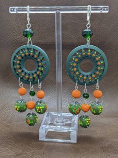 Beautiful hand painted wooden earrings with glass beads. Really fun and colorful to wear. Bohemian Multicolor Wooden Bead Earrings, Multicolor Wooden Beads Dangle Earrings, Multicolor Wooden Beaded Earrings As A Gift, Green Handmade Fun Earrings, Handmade Green Beaded Earrings, Multicolor Dangle Beaded Earrings With Wooden Beads, Green Hand-painted Bohemian Earrings, Green Beaded Fun Earrings, Green Hand Painted Bohemian Earrings