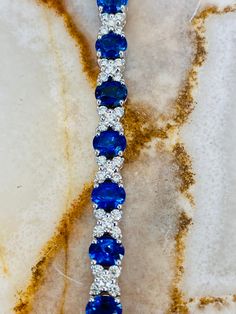 This 18K white gold bracelet features individual links set with round Blue Sapphires and White Diamonds. Sapphires total 5.58ctw in carat weight Diamonds total 1.71ctw in carat weight Blue Brilliant Cut Diamond Bracelet For Formal Occasions, Luxury Blue Diamond Bracelet With Brilliant Cut, Blue Diamond Bracelet With Brilliant Cut Luxury Style, Luxury Blue Diamond Bracelet For Formal Occasions, Luxury Blue Diamond Bracelet For Formal Events, Sapphire Color Brilliant-cut Cubic Zirconia Bracelets, Blue Tennis Bracelet With Prong Setting For Formal Occasions, Luxury Blue Tennis Bracelet, Luxury Blue Gemstone Diamond Bracelet