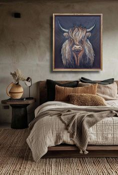 a bedroom with a large painting on the wall above it and a bed covered in pillows