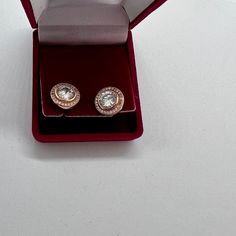 A lovely pair of vintage rose gold plated on silver cubic zirconia faux diamond stud earrings. These pretty earrings have a large faux diamond zirconia stone set at the centre that is circular in shape and measures 7mm making the earring an eye catching statement piece. Each stone is surrounded by a circle of tiny stones giving these earrings a real sparkle. The earring measure 12mm and are circular in shape with butterfly backs. Each earring is marked 925 on the post for silver. The earrings we Rose Gold Cubic Zirconia Diamond Earrings With Sparkling Stones, Formal Rose Gold Earrings With Halo Setting, Rose Gold Cubic Zirconia Earrings With Halo Setting, Rose Gold Halo Setting Cubic Zirconia Earrings, Round Rose Gold Earrings With Halo Setting, Formal Rose Gold Earrings With Sparkling Stones, Classic Rose Gold Earrings With Halo Setting, Rose Gold Diamond Earrings With Halo Setting For Gift, Rose Gold Halo Setting Diamond Earrings