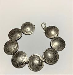 Coins - Vintage Buffalo Nickle Coin Bracelet Sterling Silver Links. Sterling silver links & clasp. Fits wrist size 7 inches. Larger sizes available. Feel free to ask for a size larger than what is listed. Elegant Stamped Bracelet, Elegant Round Stamped Bracelets, Collectible Sterling Silver Bracelet, Classic Silver Stamped Bracelets, Classic Metal Bracelets, Silver Collectible Bracelets, Collectible Silver Jubilee Bracelet, Vintage Bangle Bracelet With Sterling Silver Clasp, Antique Silver Bracelet With Jubilee Detail