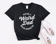 This vintage style T-Shirt with the phrase 'Having A Weird Dad Builds Character' is perfect for anyone looking to add a touch of nostalgia and humor to their wardrobe. It exudes a laid-back and quirky vibe, making it an ideal choice for those who appreciate unique and fun fashion statements. This T-Shirt is relevant for Father's Day, birthdays, and any casual occasions where you want to showcase your personality. Product features - Made with 100% ring-spun cotton for lightweight comfort - Classi Funny Cotton T-shirt With Lettering, Funny Short Sleeve T-shirt With Lettering, Funny Dad Shirts, Father Gift, Fashion Statements, Retro Tee, Character Building, Dad Humor, Fun Fashion