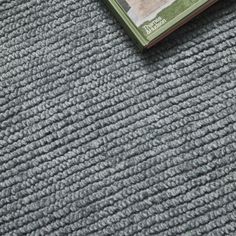 a book laying on top of a gray carpet