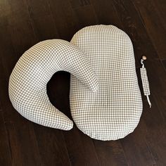 an elephant shaped pillow sitting on top of a hard wood floor next to a pen