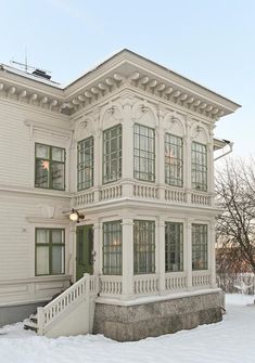 a large white house with many windows and balconies