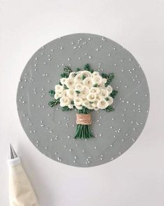 a bouquet of white flowers sitting on top of a gray plate