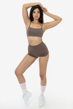 These cheeky hot shorts have a vintage, sporty-inspired look. Made of our heavyweight cotton spandex, these shorts feature a multi-needle elastic waist and curved dolphin hem and have been garment dyed for a rich, smooth finish. Pair with our matching 83016GD Spaghetti Bralette or any of our rib tanks for a timeless look. Perfect for at-home workouts or roller skating by the beach. Runs small, we recommend sizing up one size if you are in between sizes. Made in South Central, Los Angeles. Our ex High-waisted Cotton Shorts For Gym, Sporty High Waist Cotton Athletic Shorts, Sporty High-waist Cotton Athletic Shorts, High Waist Cotton Sports Shorts, Sporty High Waist Cotton Shorts, Sporty Crop Top With Built-in Shorts, Cotton Boxer Briefs For Workout, High Waist Seamless Gym Shorts, High Waist Cotton Stretch Biker Shorts