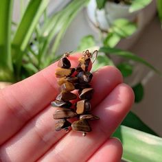 a person is holding some small beads in their hand