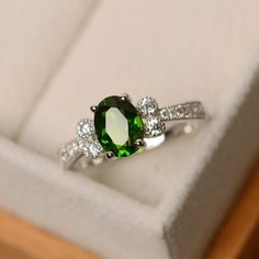 This ring features a 6*8mm oval cut diopside and sterling silver finished with rhodium. Customization is available. It is made by hand, and it will take about 7 days to finish the ring after your payment is completed. Main stone: Diopside Main stone weight: Approx 1.50 ct Metal type: sterling silver finished with rhodium Accent stone: cz Customization is available, I also can make it with 14k solid gold (white or yellow or rose) and diamond accent stone, just feel free to contact me. Any questio Green Oval Sapphire Promise Ring, Oval Tsavorite Ring In White Gold, Oval Tsavorite White Gold Ring, Classic Oval Green Sapphire Ring, Classic Green Oval Sapphire Ring, Classic Green Sapphire Oval Ring, Oval Tourmaline Ring For May Birthstone, Oval Tourmaline White Gold Rings, Classic Oval Tourmaline Emerald Ring