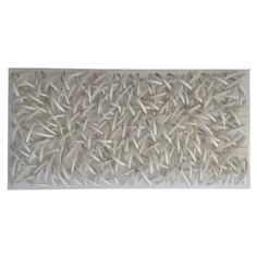 a white wall hanging with many different types of sticks on it's sides and the bottom