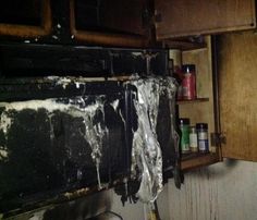 the inside of a kitchen that has been gutted and burned with tin foil on it