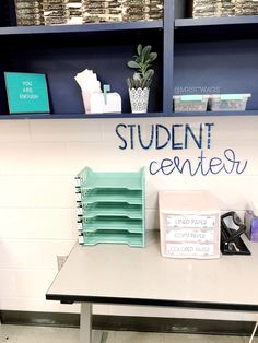 a desk with some books on it and a sign that says student center next to it