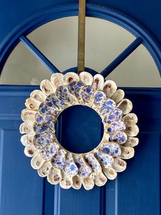 a blue door with a wreath hanging on it