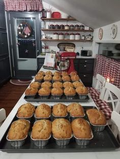 muffins are lined up in pans on a counter top next to an oven