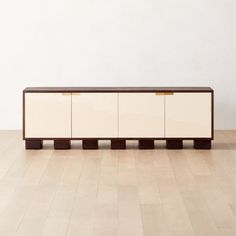 a white and brown cabinet sitting on top of a hard wood floor