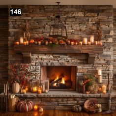 a fireplace with candles and pumpkins on the mantle