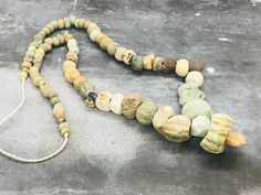 "These wonderful beads were excavated along the Silk Road in Afghanistan. \"The terms \"Roman\" and \"Roman period\" glass are used to describe glass production from 100 BC to AD 400 within the boundaries of the Roman Empire, including factories in Syria, Egypt, Italy, Switzerland, the Rhineland, France and England. Everywhere the Romans went, they brought glass beads to trade.\" From \"History of Beads\" by Lois Sherr Dubin, pages 55-58. To wear as it is or to use for your own projects! ✔️Roman Ancient Handmade Healing Necklace, Ancient Style Pendant Necklaces, Handmade Ancient Style Necklaces With Round Beads, Vintage Necklace With Round Gemstone Beads, Jewelry Ancient, The Silk Road, Ancient Roman Glass, The Roman Empire, Archaeological Finds